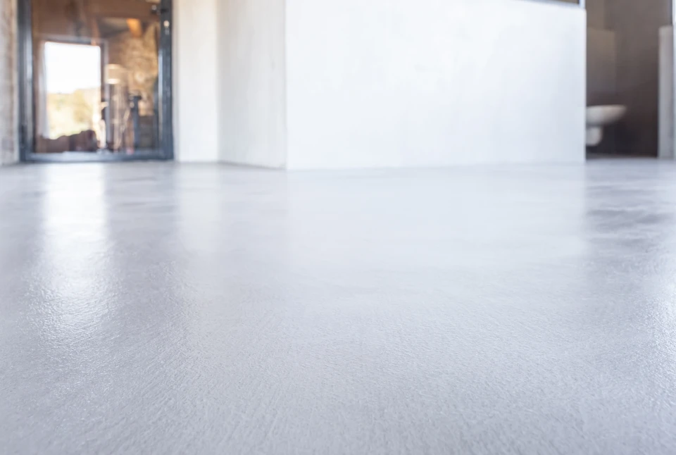 Intérieur moderne minimaliste avec deux fauteuils design gris face à face, séparés par coussins blancs au sol